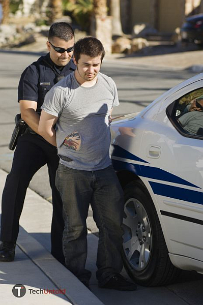 Police officer arrests a man